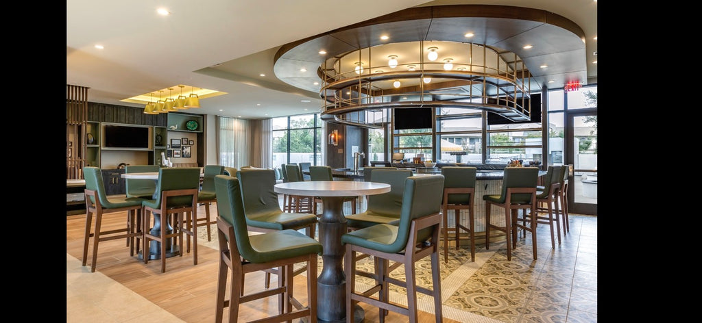 Dining area with round tables and chairs in a modern interior setting.