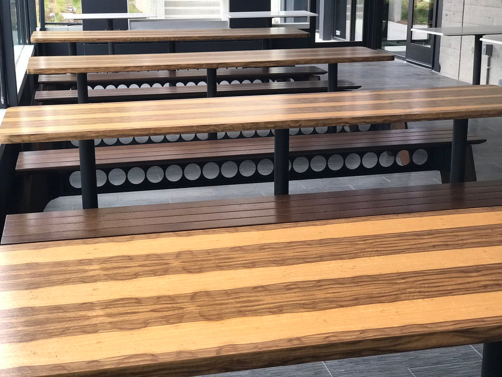 Wooden tables with metal legs in an indoor setting