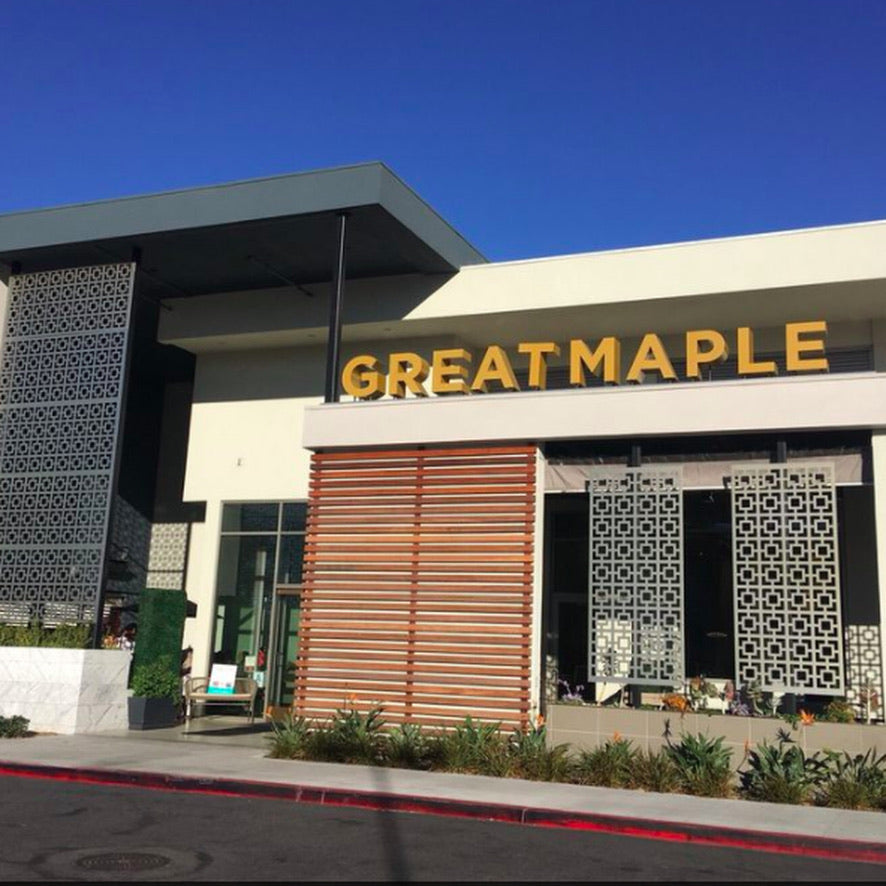 Building with 'GREATMAPLE' sign on a clear day