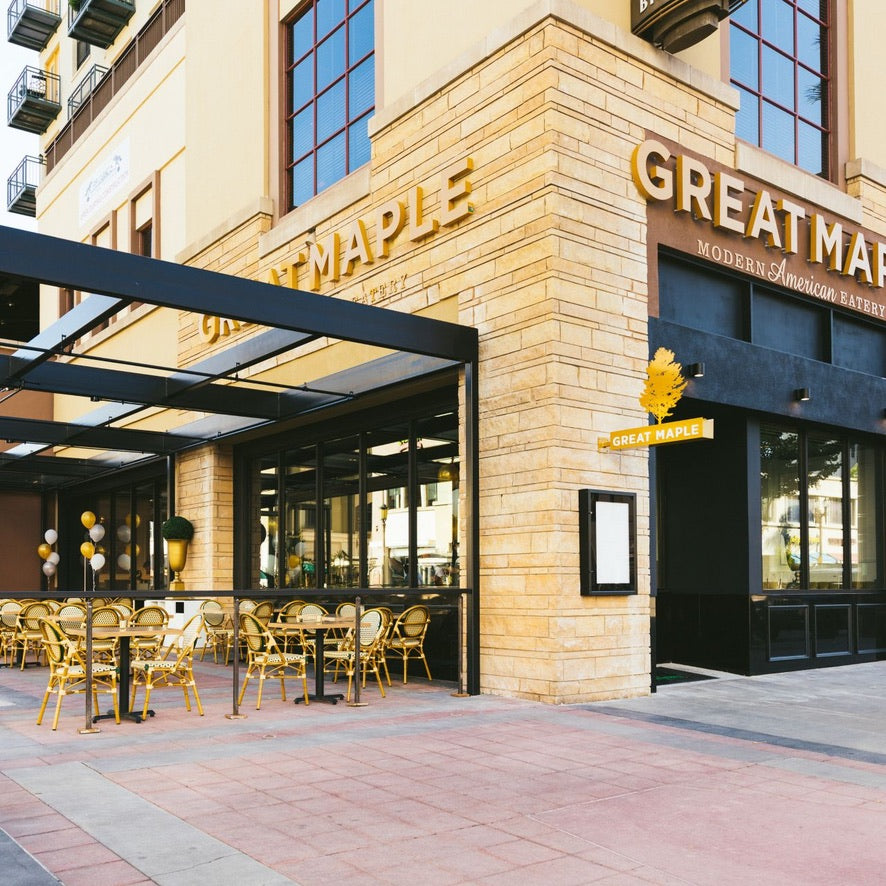 Restaurant exterior with 'Great Maple' sign and outdoor seating area.