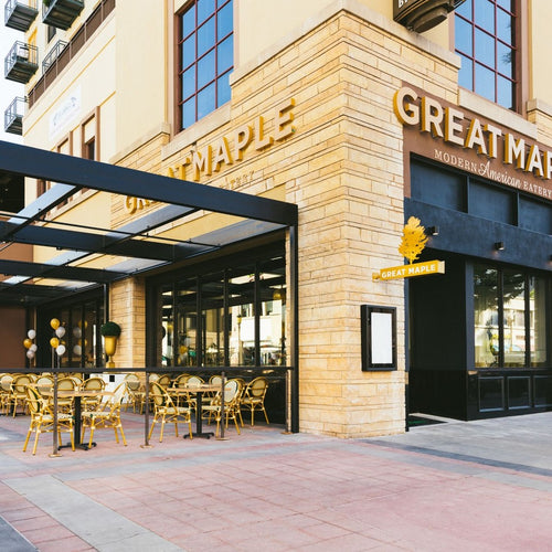 Restaurant exterior with 'Great Maple' sign and outdoor seating area.