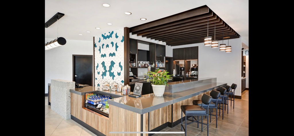Modern office reception area with a reception desk, chairs, and decorative elements.