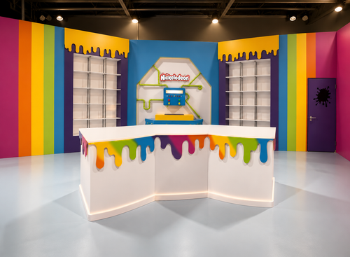 Colorful room with a children's play area featuring a rainbow design on the walls and floor.