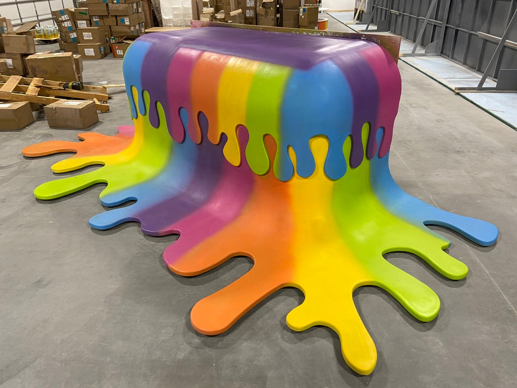 Colorful splatter-style stool in a warehouse setting